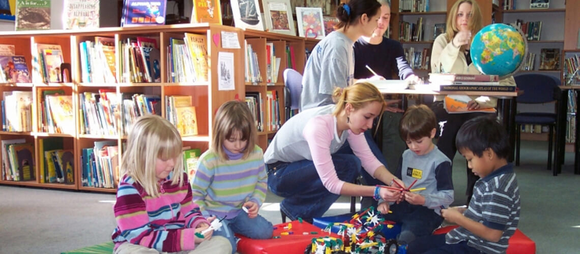 Kids and a teacher in the school library
