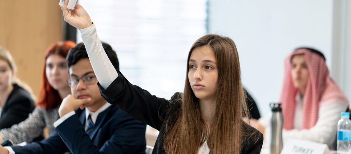 Student raising her hand in class